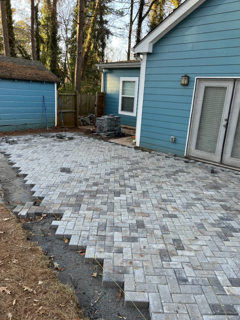 Backyard paver patio laying and outdoor living space construction