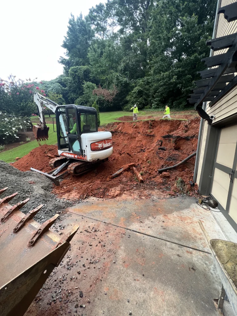 Excavation equipment clearing ground for residential masonry project