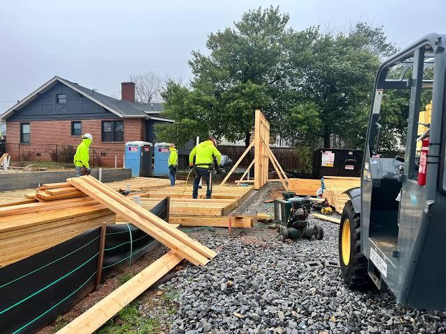 Construction site framing and lumber preparation for residential masonry build in Sandy Springs GA